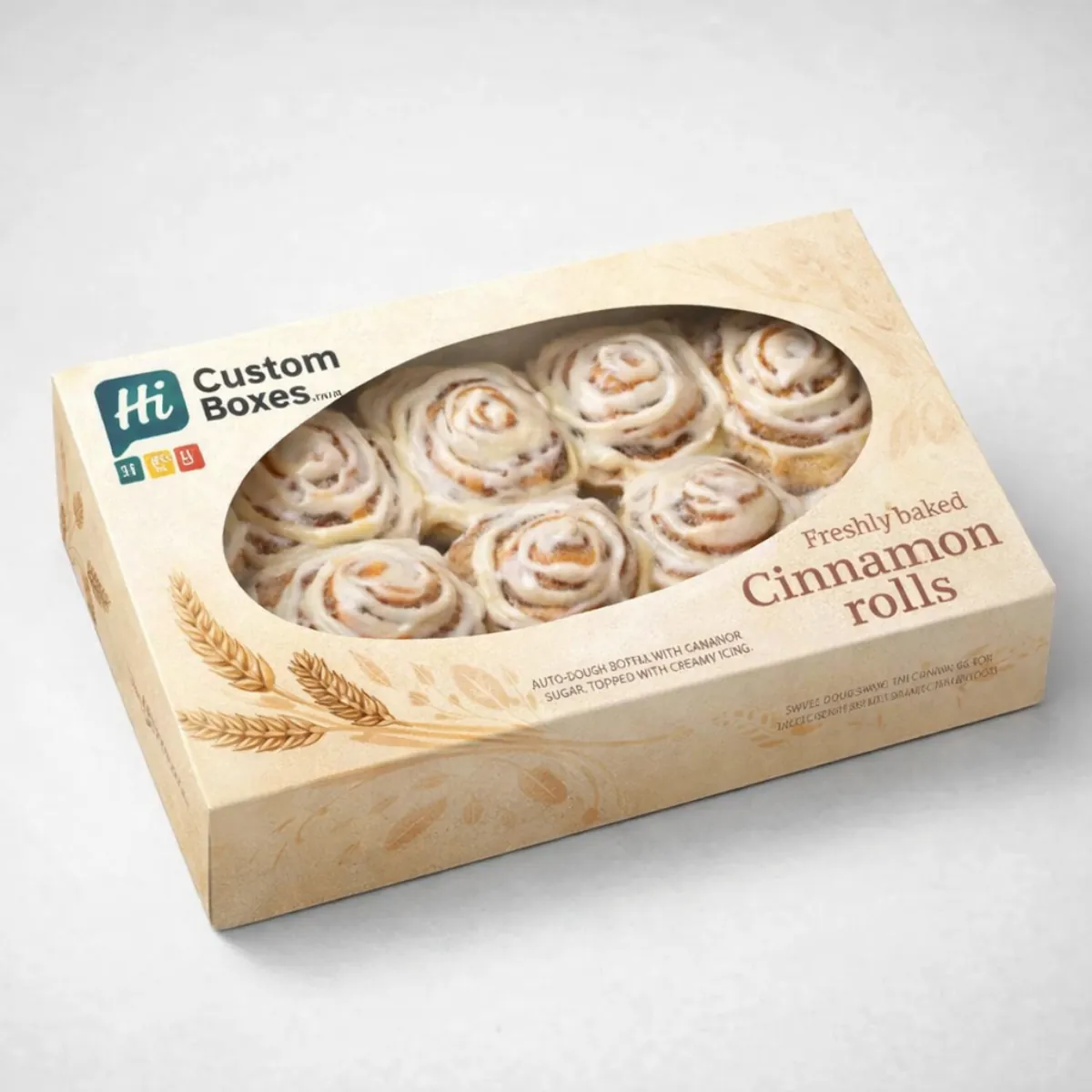 A luxury presentation box with an oval window showcasing eight delicious cinnamon rolls topped with white icing.